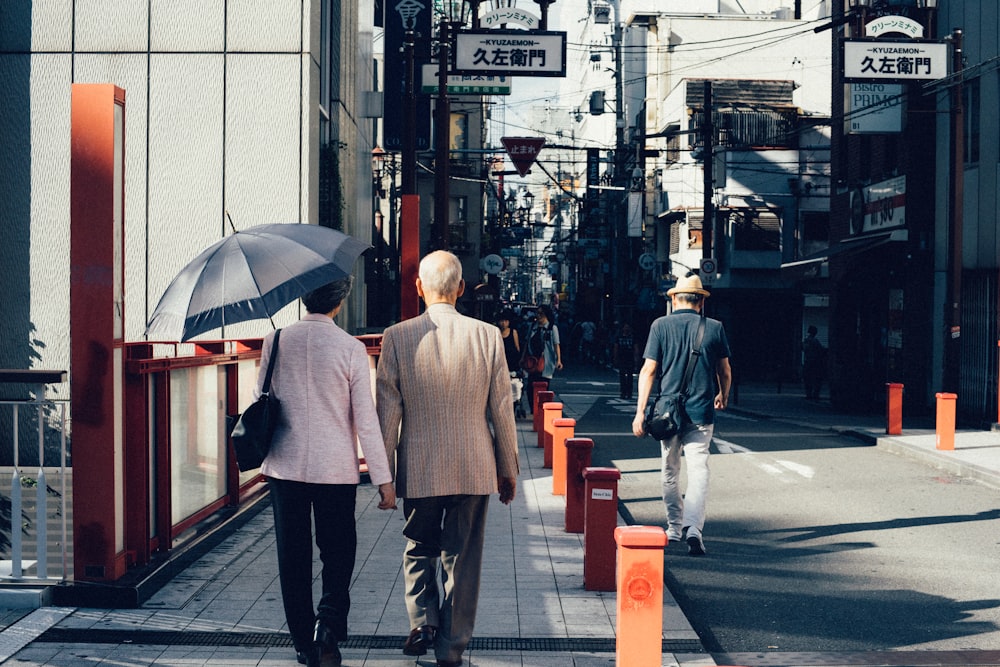 man and woman walking on concrete walkway