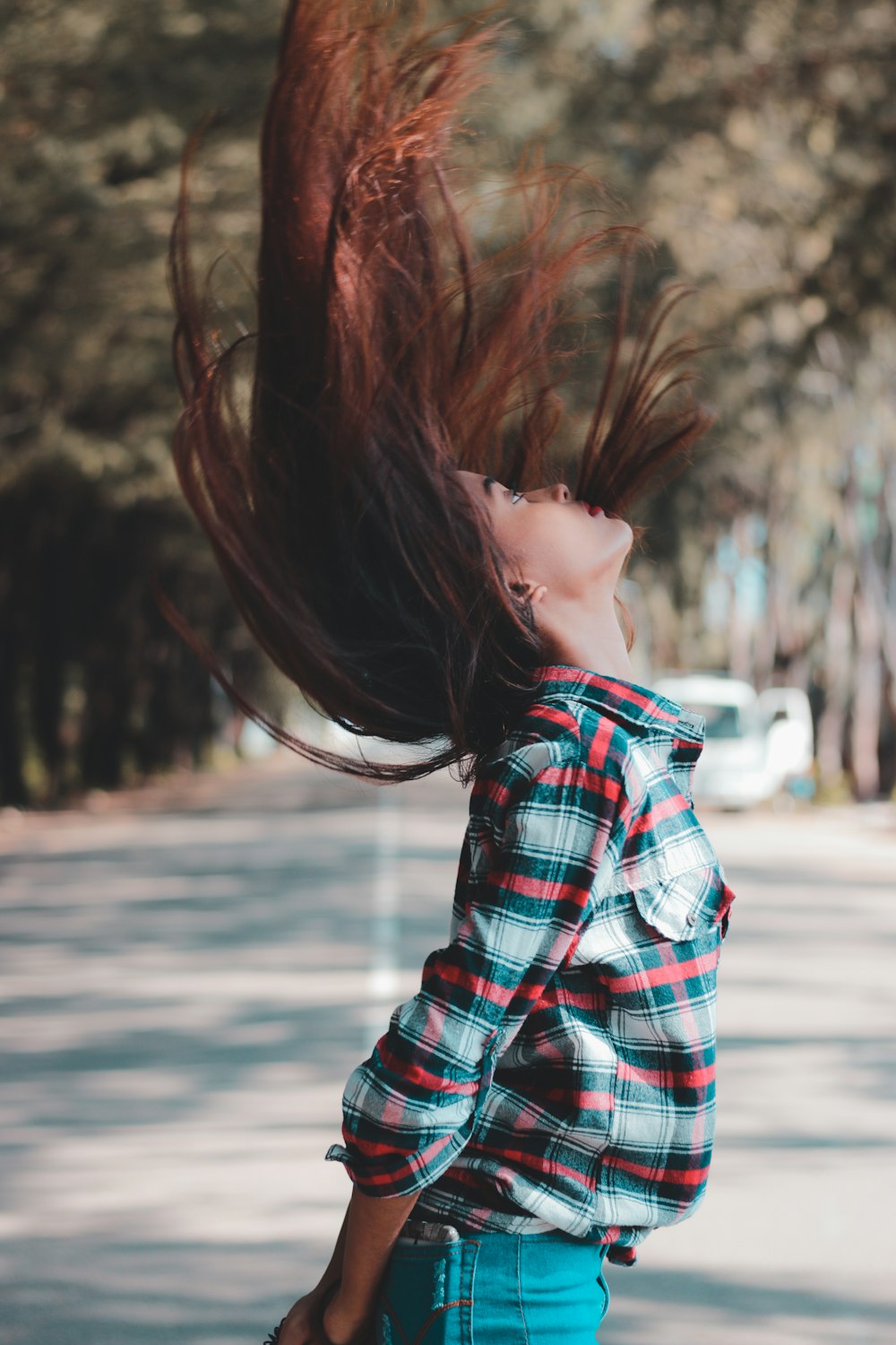 woman flipping her hair near road