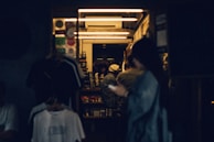 Editorial shot of a group of friends wearing various pieces from the collection, sharing a quiet moment at a minimalist coffee shop.
