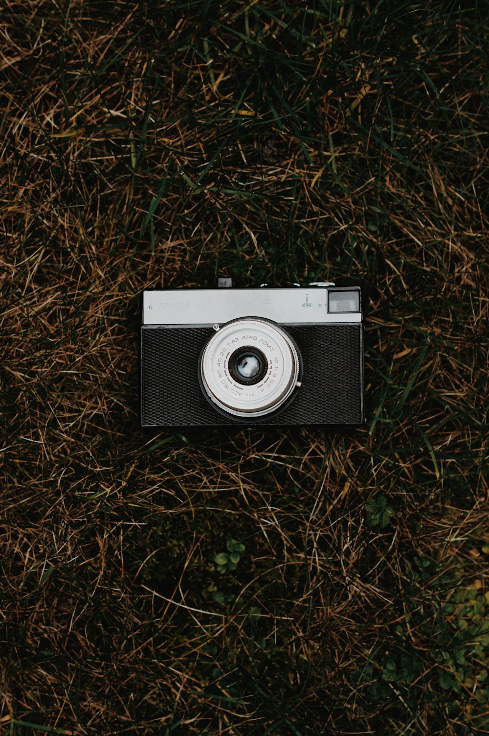 black and gray camera on grass