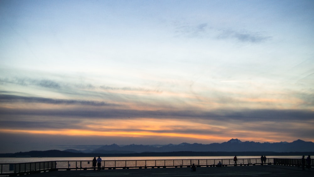 silhouette of people on beach during sunset