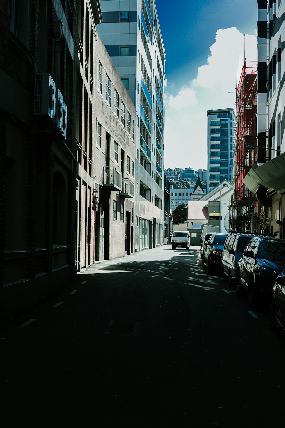 cars parked in between buildings