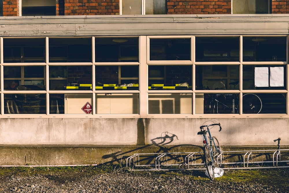 black road bike beside the building