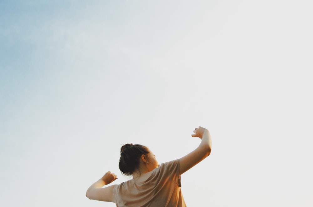 woman standing wearing gray shirt