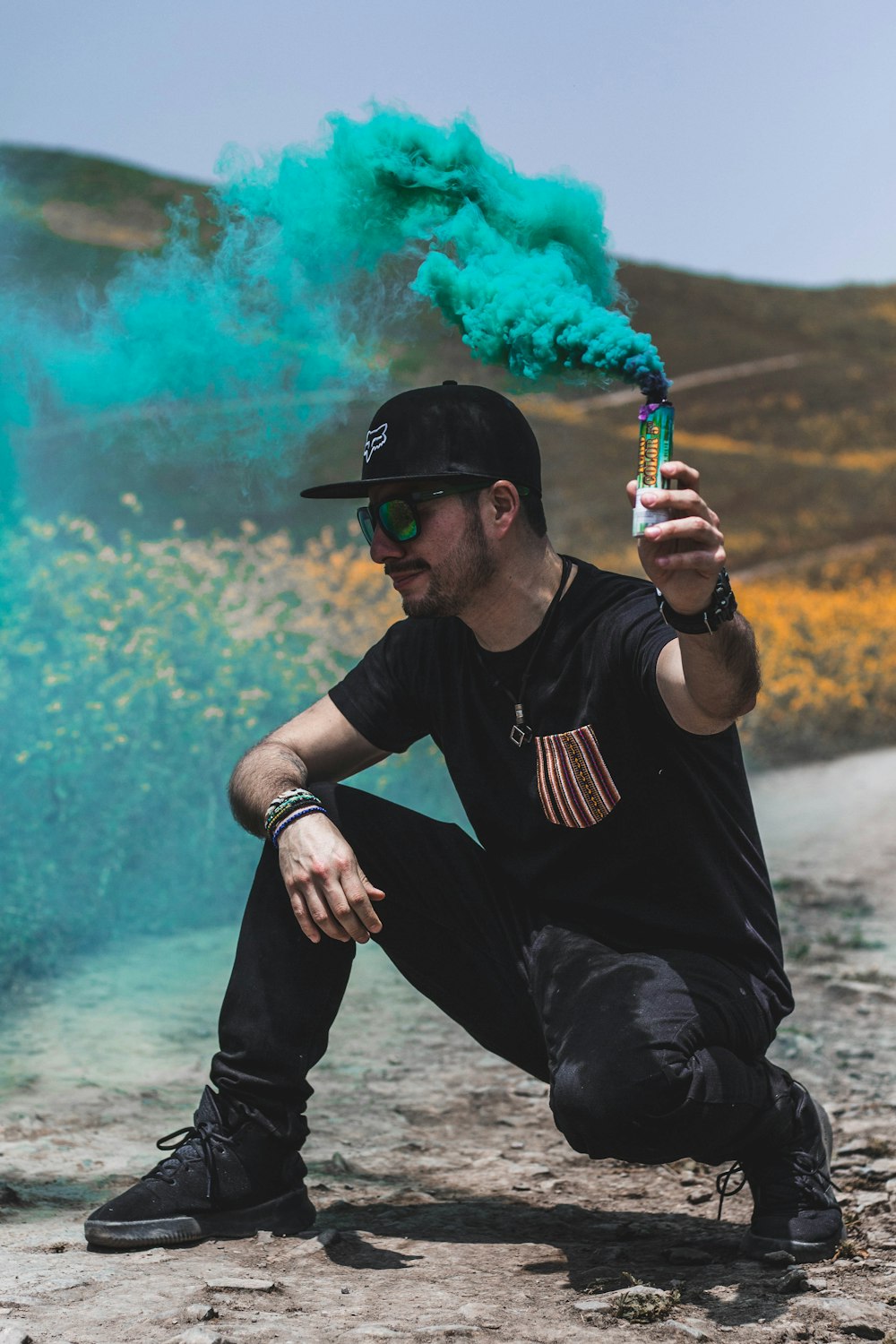 man sitting holding green gas pack