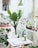 A vibrant workspace filled with plants and creative decor, showcasing a collaborative atmosphere.