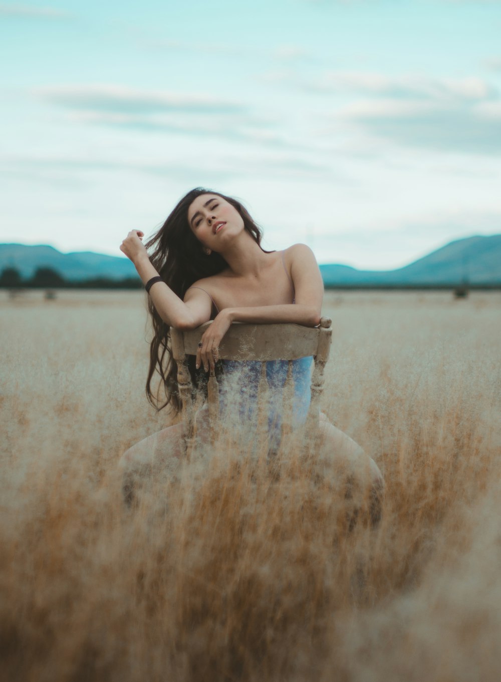 Mujer sentada en silla sin brazos al aire libre