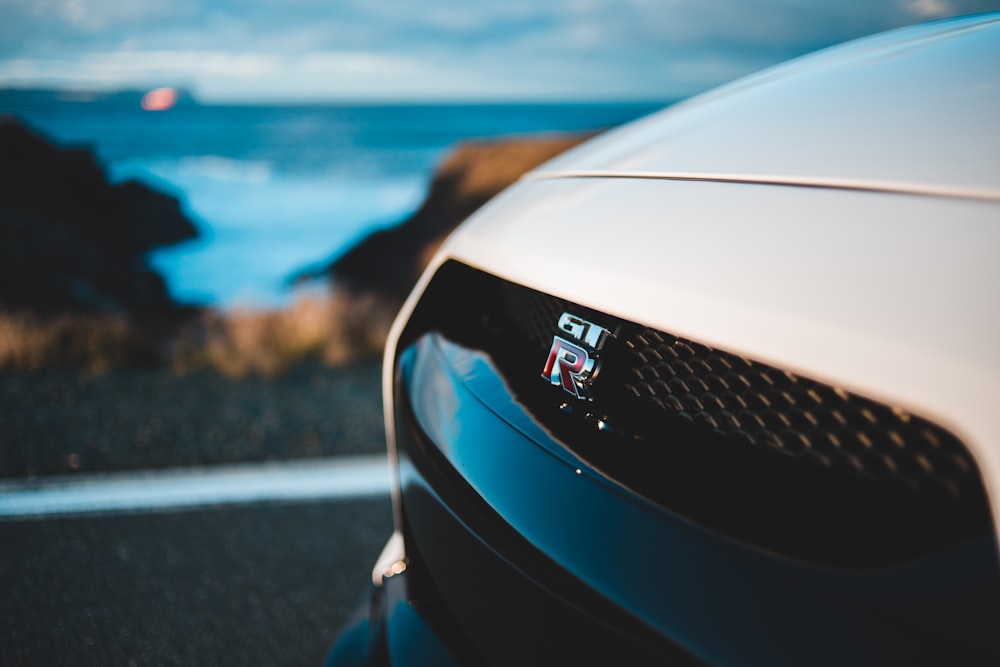 selective focus photo of white car hood