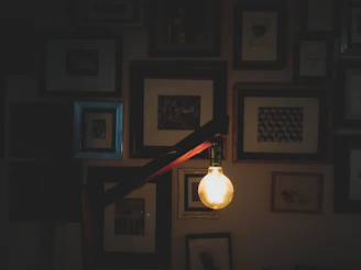A close-up of framed certificates and training diplomas hanging on a warmly lit office wall.