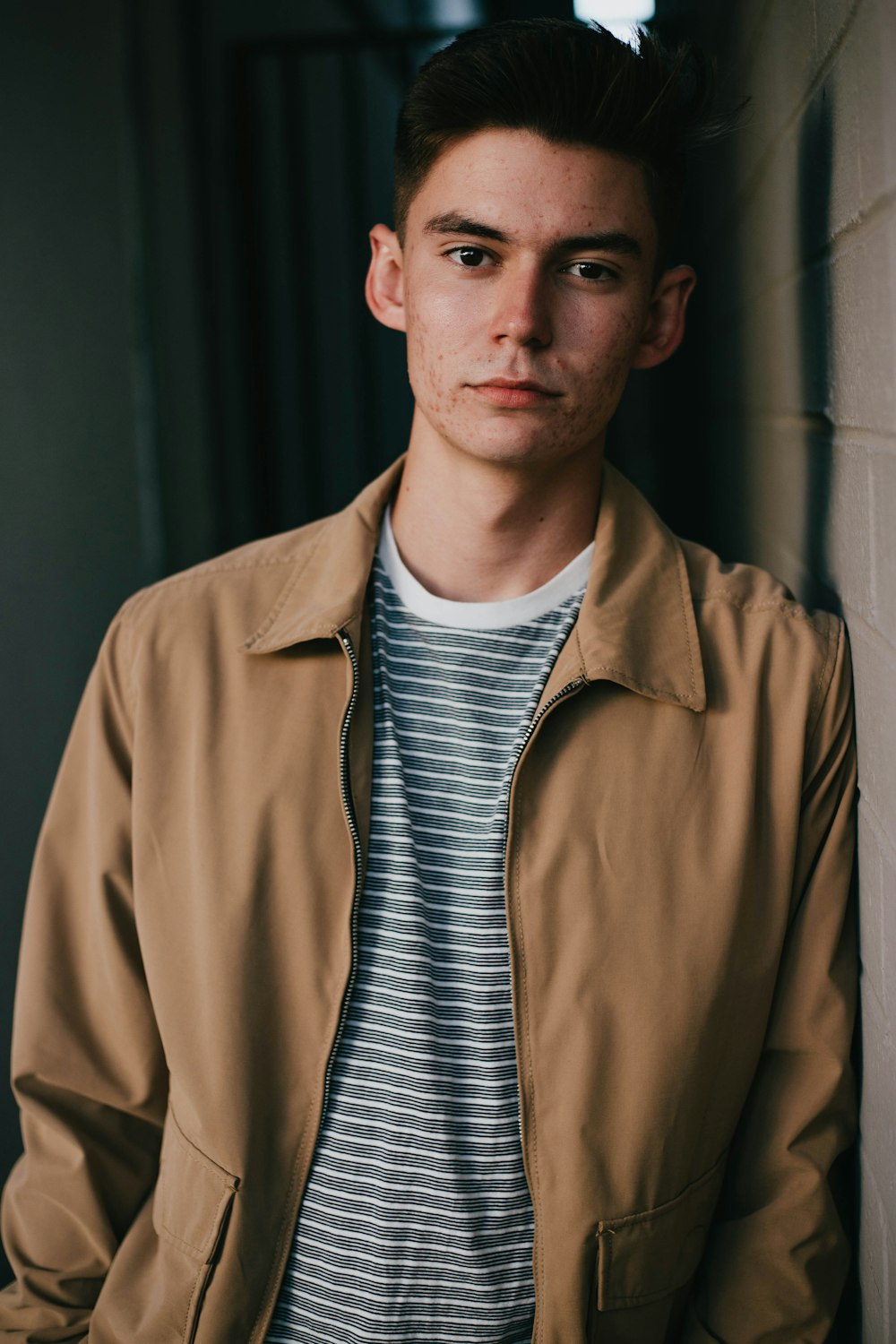 man wearing brown collared jacket