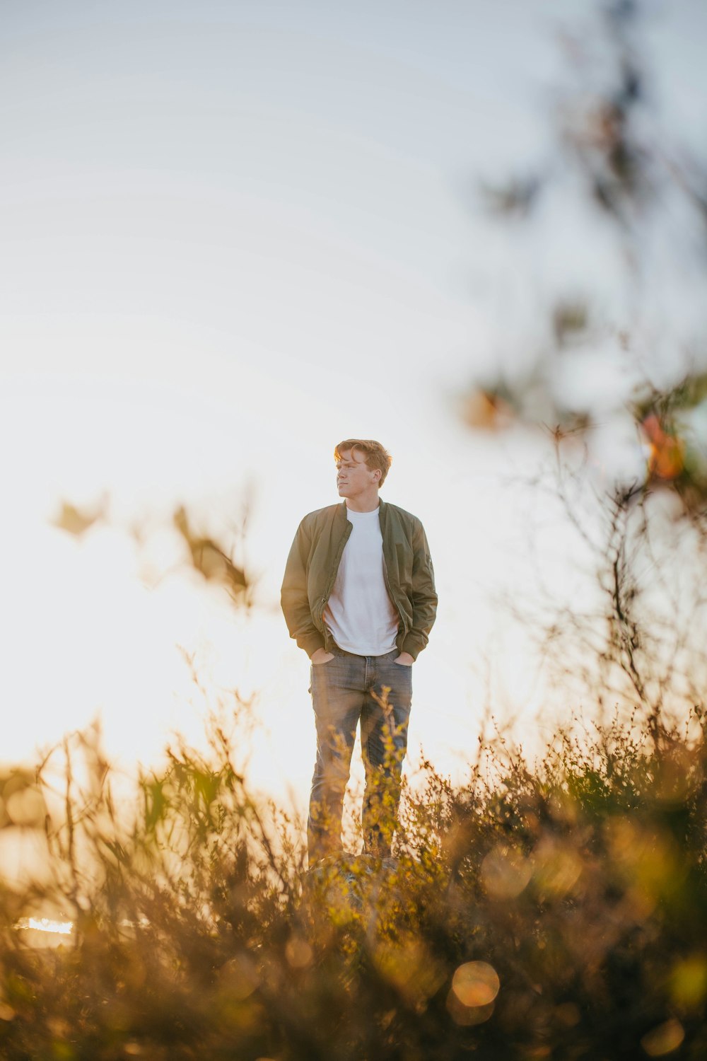 man standing on brown grass