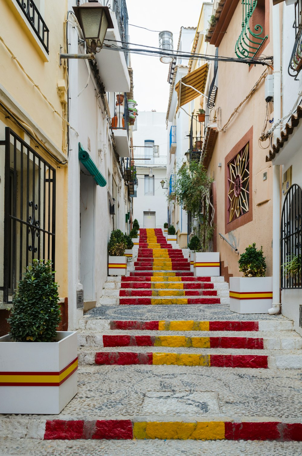 red and yellow concrete staircase between concrete house