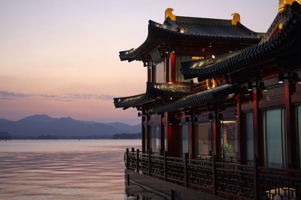 brown and red temple beside water