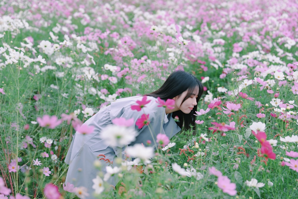 woman wearing blue dress in flower graden