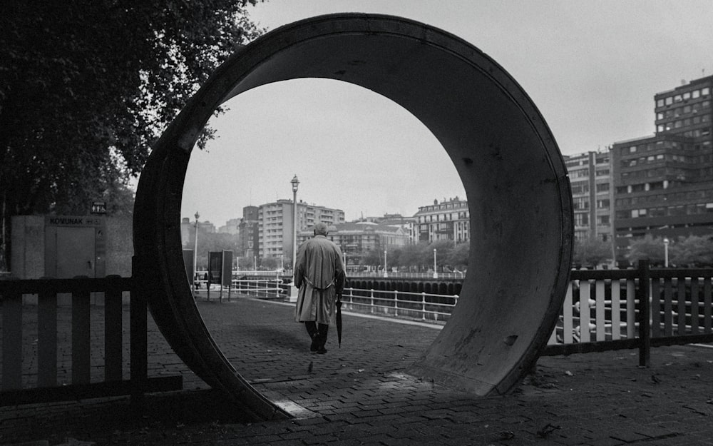 grayscale photo of person holding umbrella