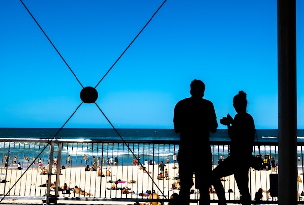 Happy couple enjoying a balcony overlooking the beach.