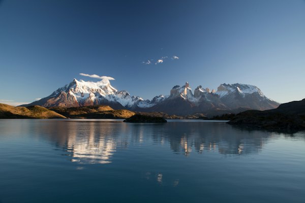 Snow covered mountain in reflective photography — Torres del Paine, Chile