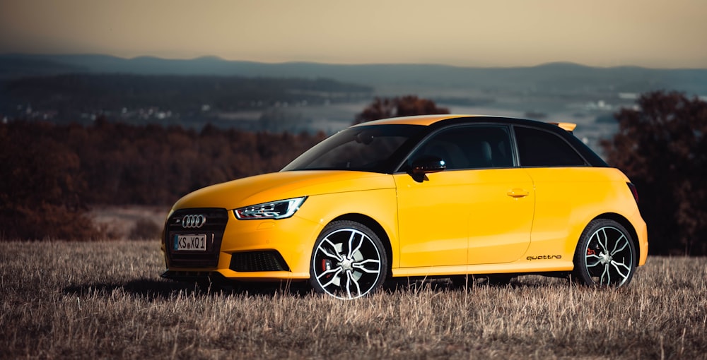 yellow Audi compact car