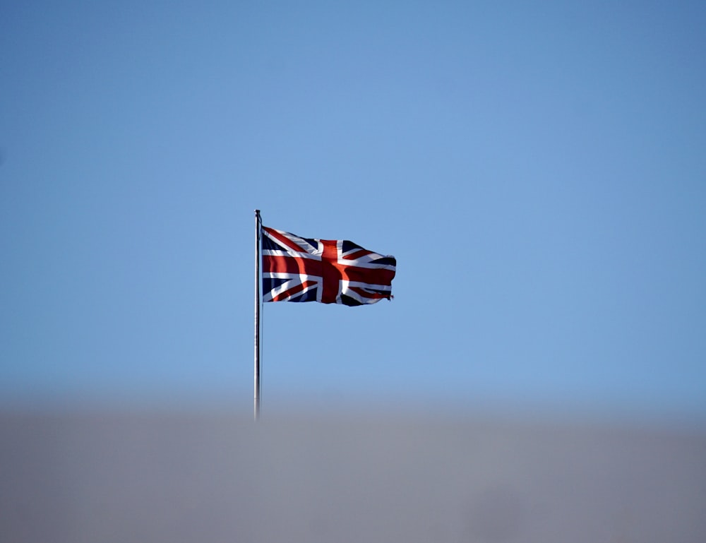 a british flag flying high in the sky