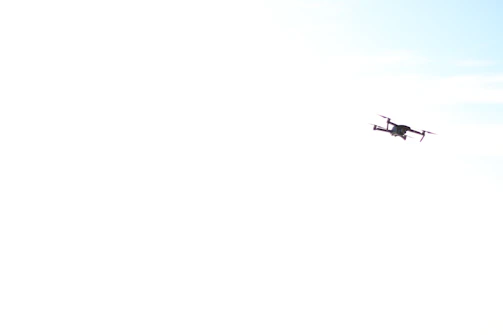 Drone flying over solar panels with clear blue sky background