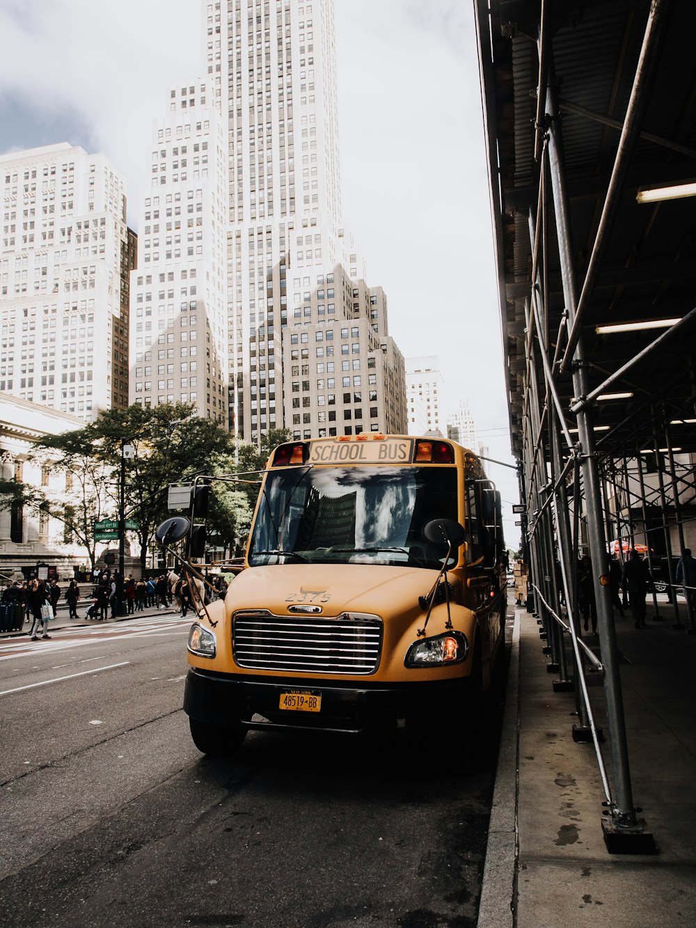 orange bus near white high-rise building