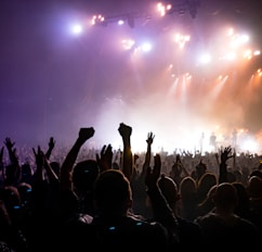 crowd facing lighted stage