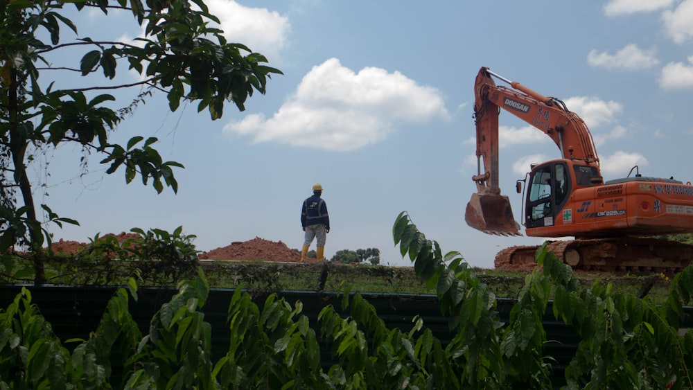 person standing near excavator