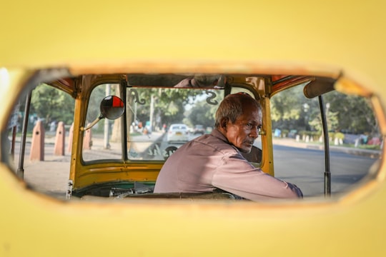 man in a yellow tricycle in New Delhi India
