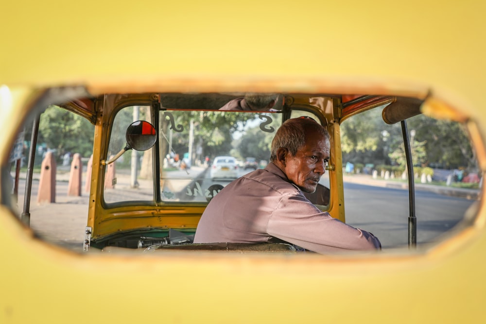 man in a yellow tricycle