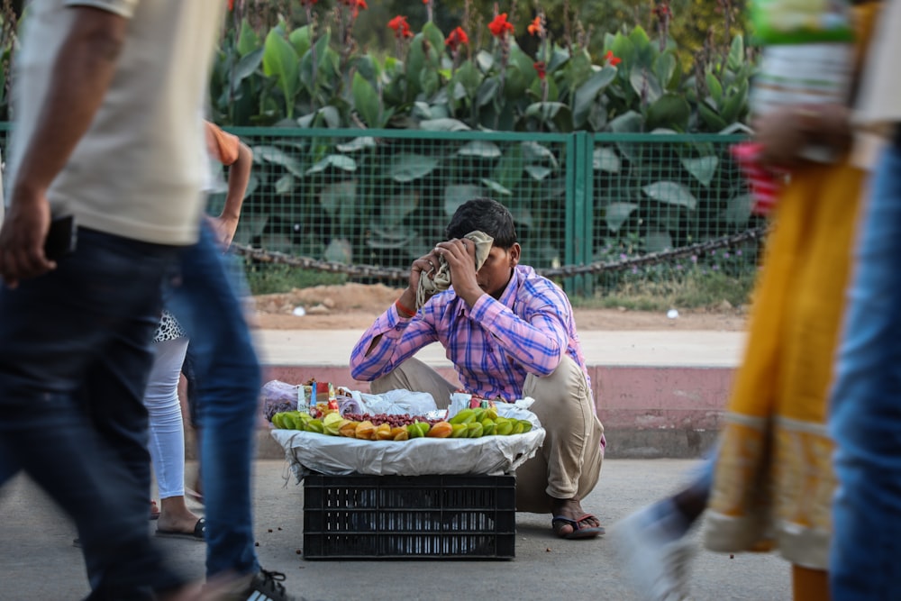 male vegetable vendor at street during daytime