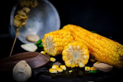 selective focus photography of three yellow corns corn zoom background