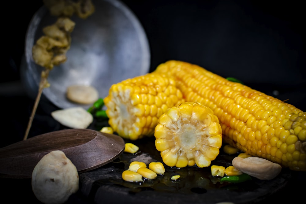 selective focus photography of three yellow corns