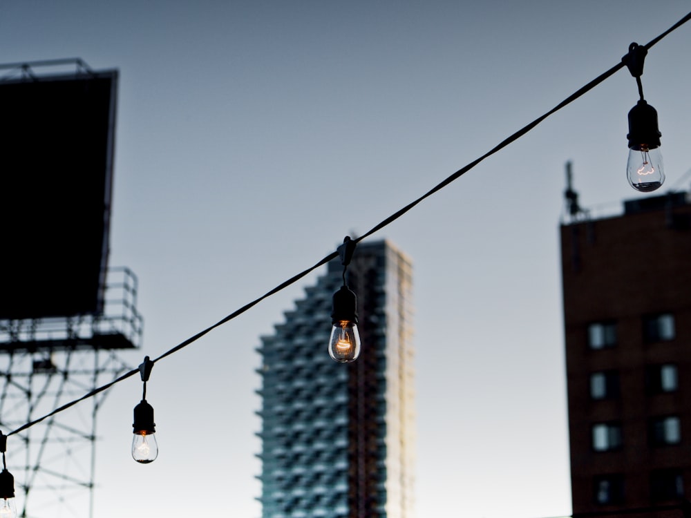 a string of light bulbs hanging from a power line