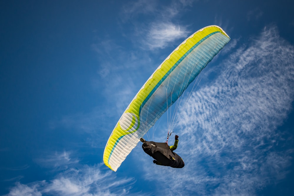 person on yellow and white parachute