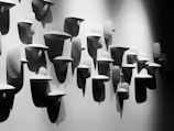 An abstract art installation displayed in a minimalist gallery setting.