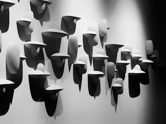 Minimalist wall installation featuring layered metal and wood elements in muted blues and greys.