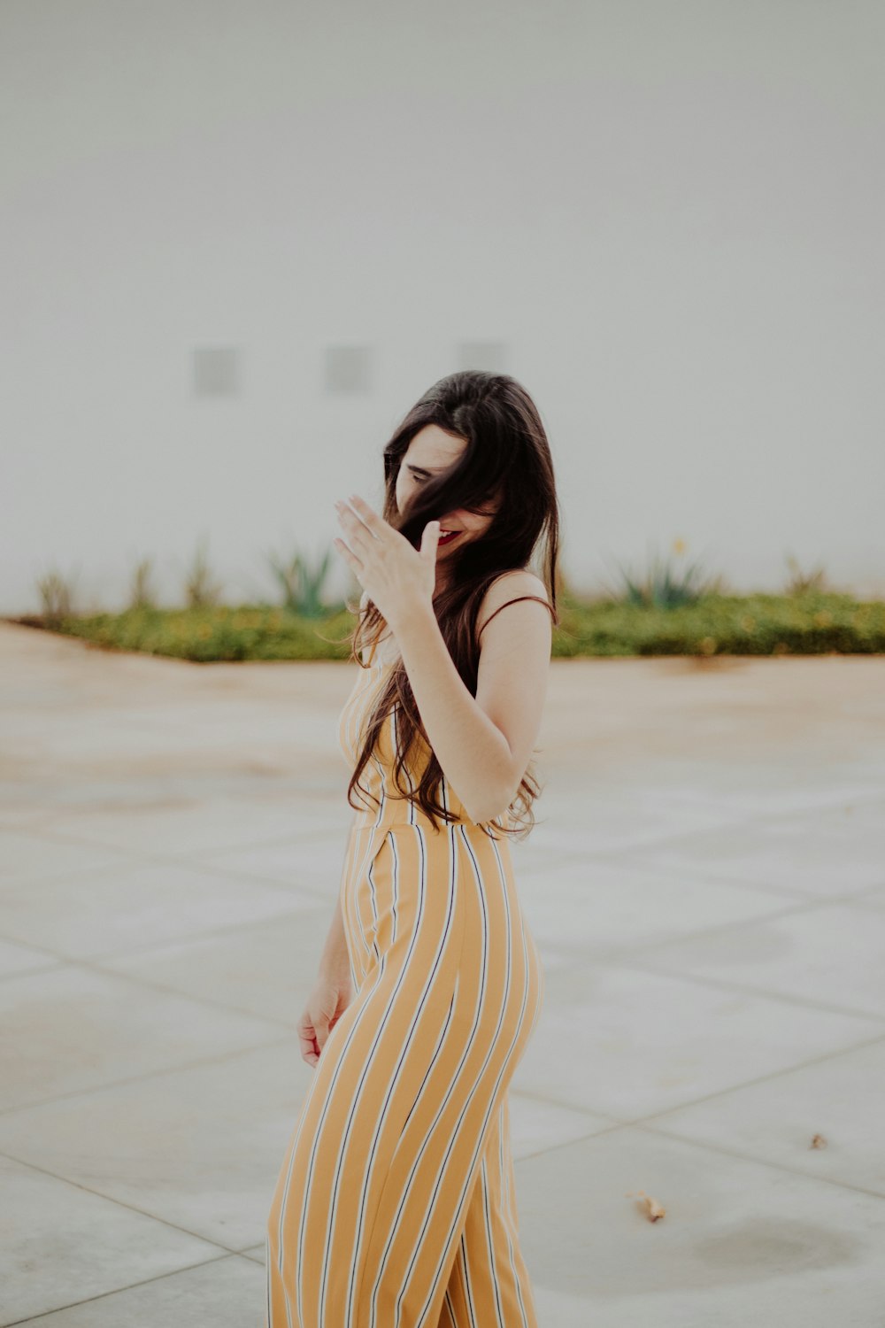 woman standing wearing yellow striped dress