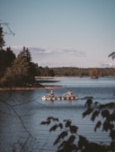 two men rowing boats in lake