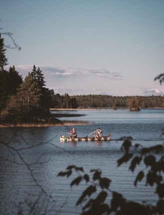 two men rowing boats in lake