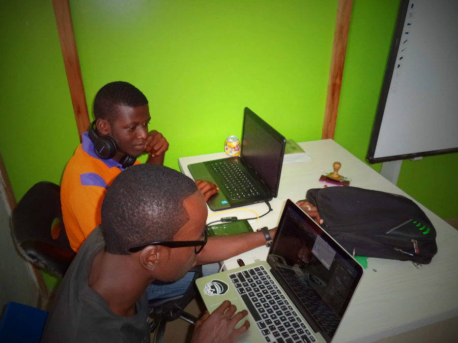 Two students collaborating at a desk in a bright classroom workspace