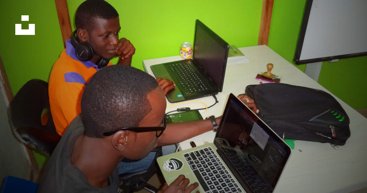 Two men using laptop computes photo – Free Nigeria Image on Unsplash