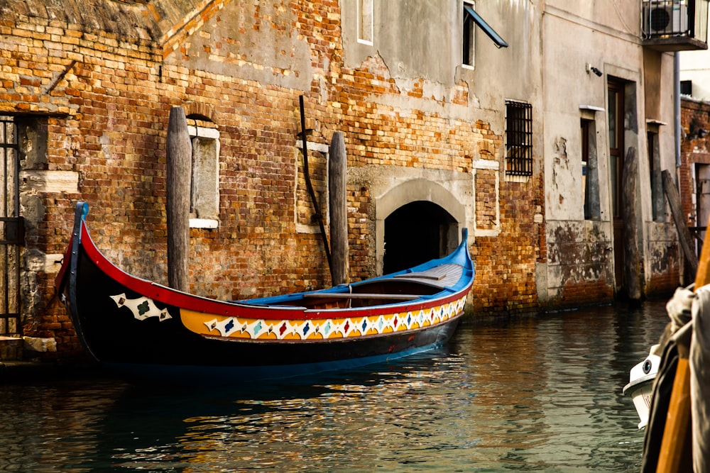 blue canoe near the brick wall