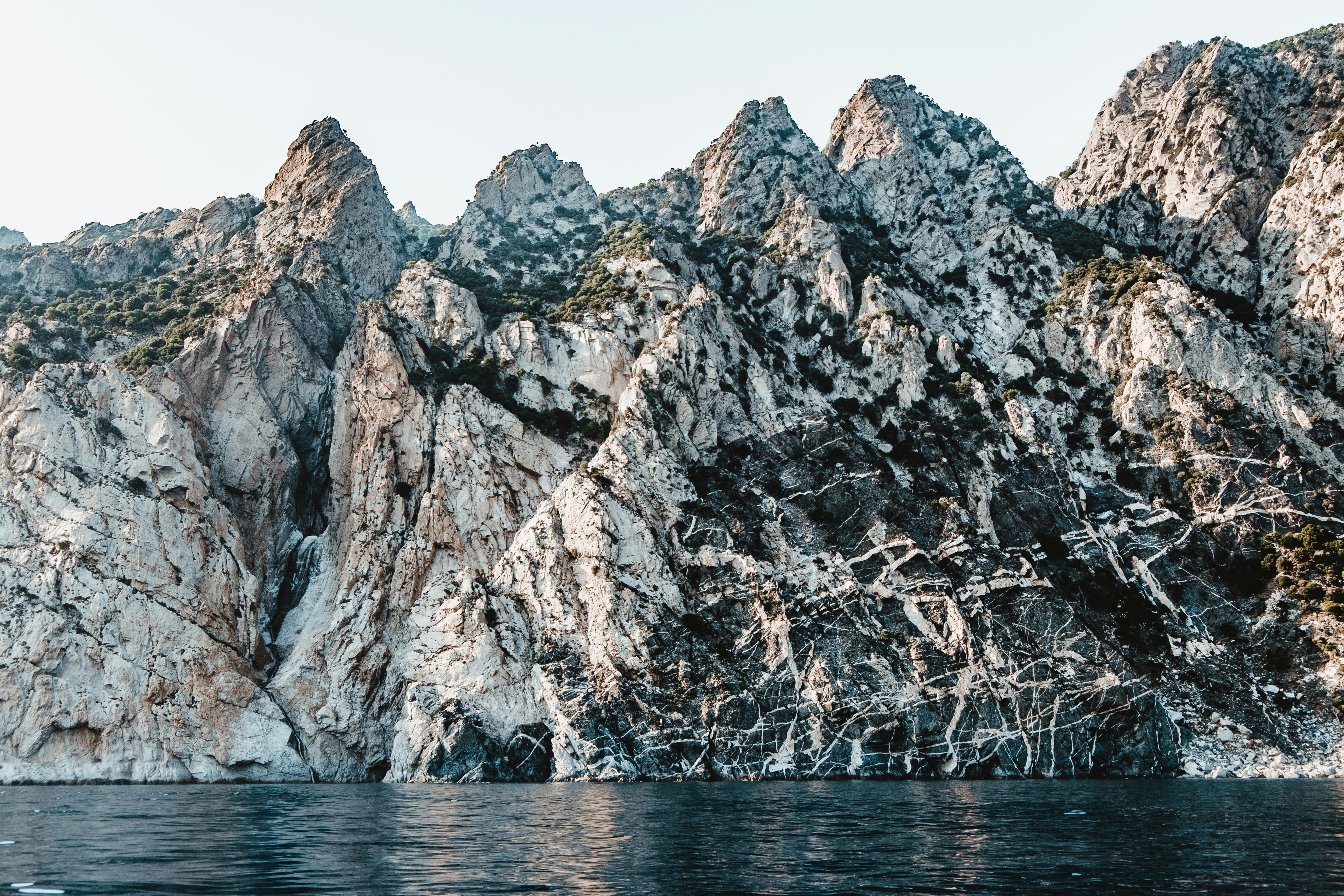 mountain near body of water during daytime