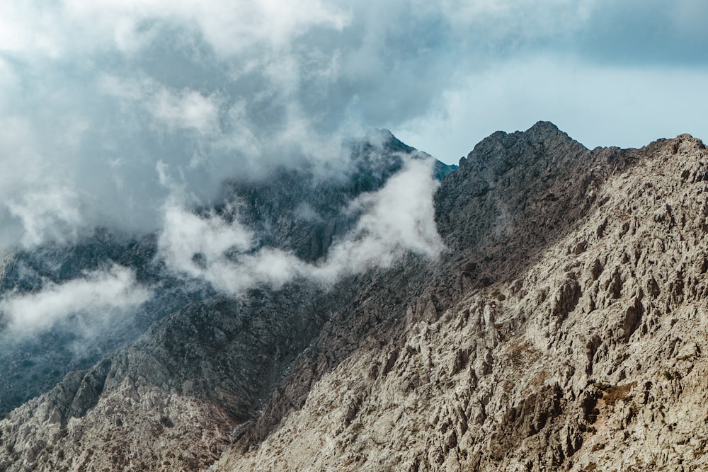 aerial photography of mountain with clouds during daytime