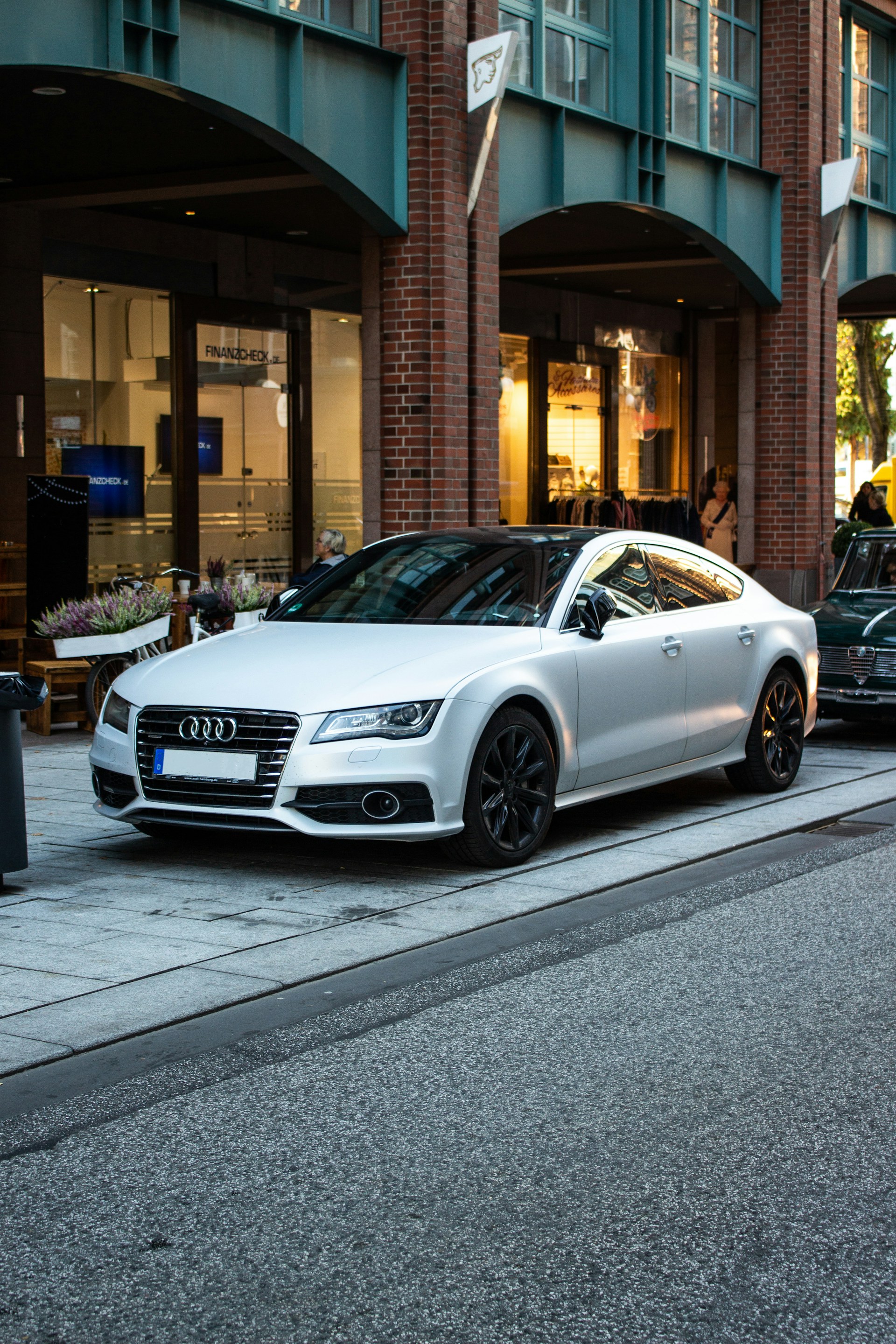silver Audi sedan parked on street beside restore