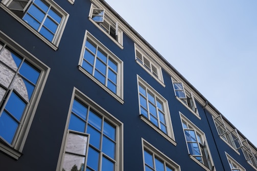 Commercial building facade with glass windows and blue accents