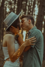 man kissing woman
