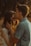 man kissing woman forehead