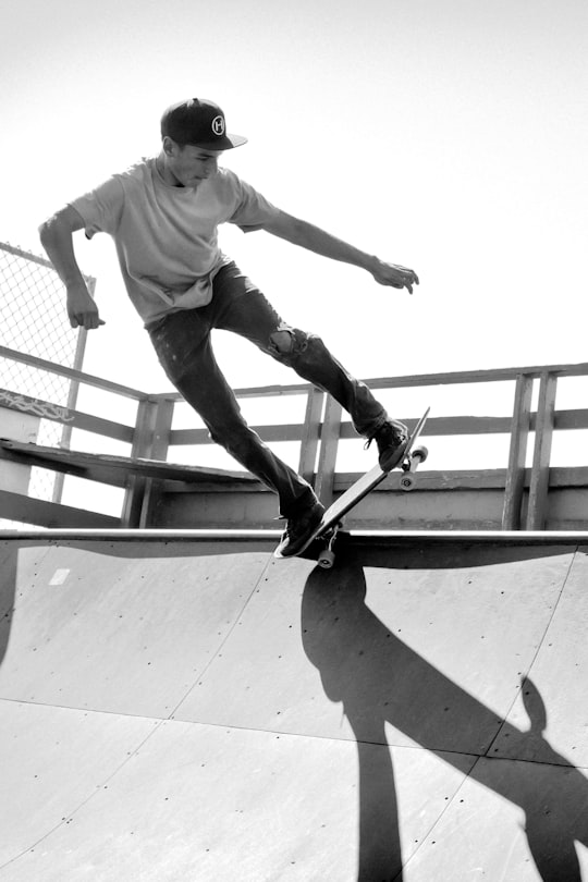 grayscale photo of man on skateboard in Cayucos United States