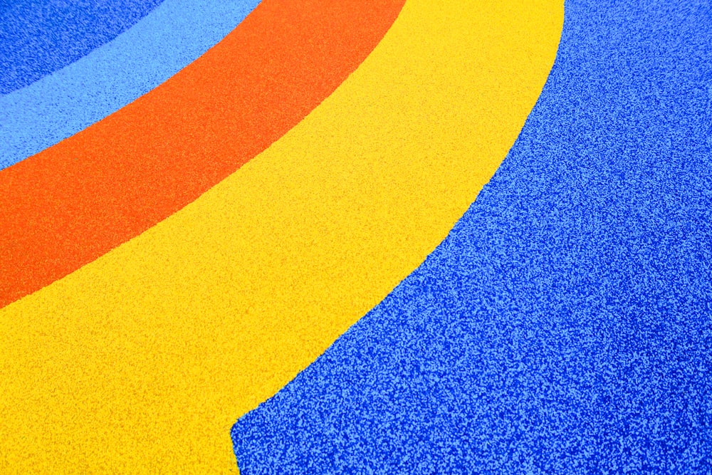 a blue, yellow, and red carpet with a curved design